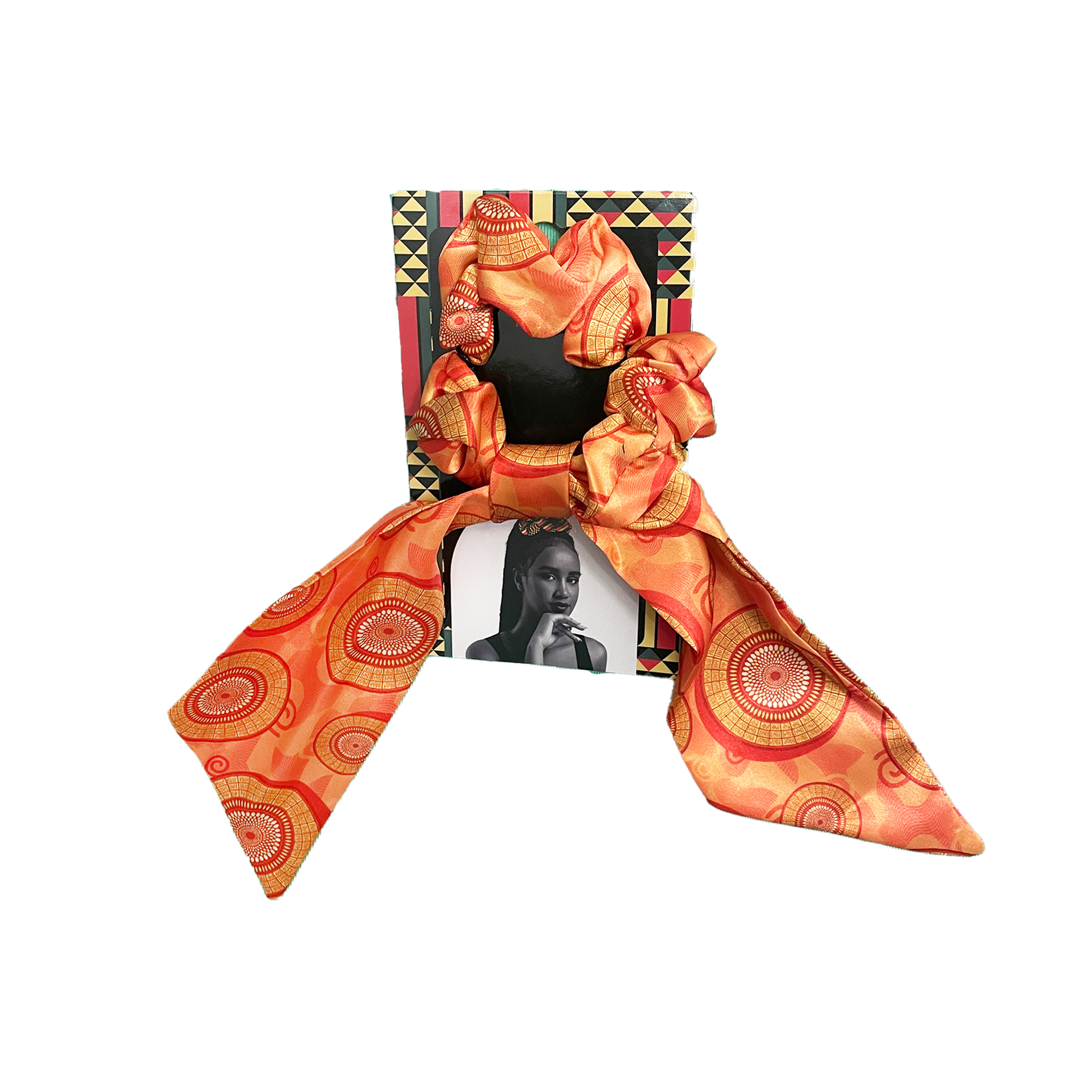 Orange and gold patterned hair scarf with a mirror and photo frame on a white background.